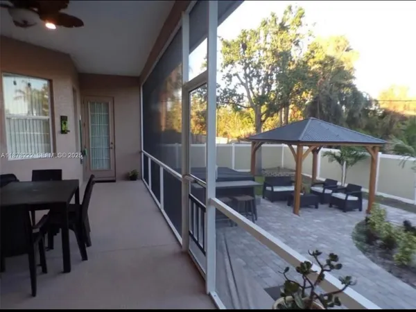 a view of a house with backyard and sitting area