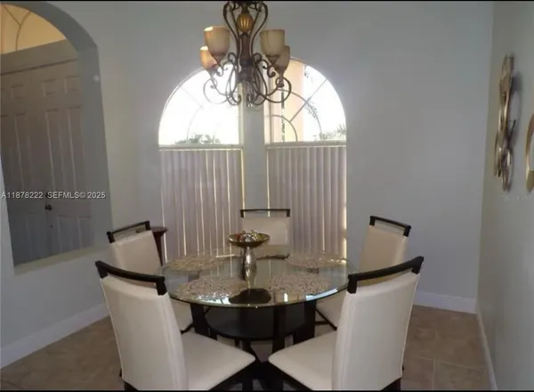 a dining room with table and chairs