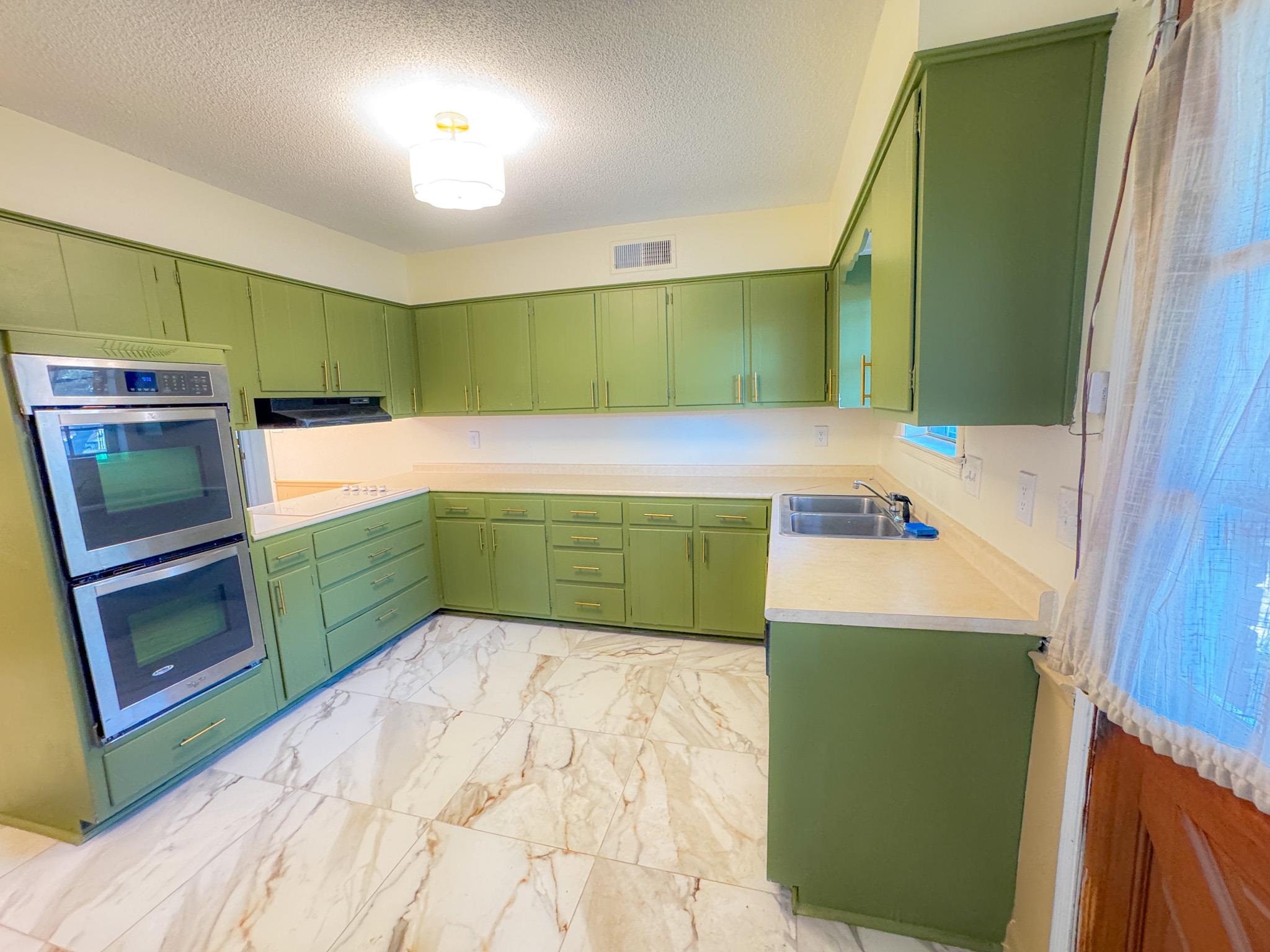 1345 Hickory Ridge Cove Memphis, TN 38116 - Photo 9 of 29 a kitchen with a refrigerator and a microwave