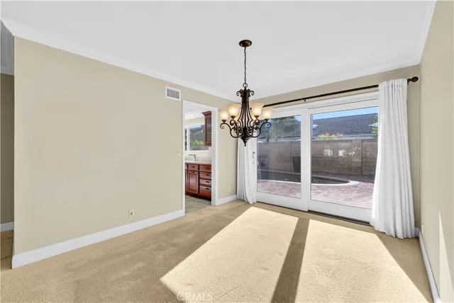 a view of an empty room with glass door and a window