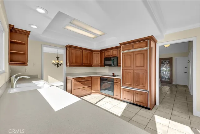 a kitchen with stainless steel appliances granite countertop sink window and refrigerator