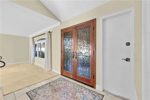 a view of an empty room with wooden floor and a bathroom
