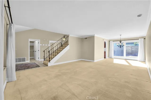 a view of a room with a ceiling fan and window