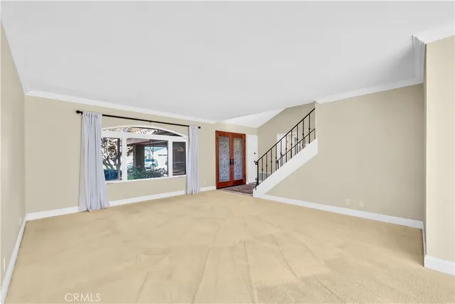a view of a room with a furniture and ceiling fan