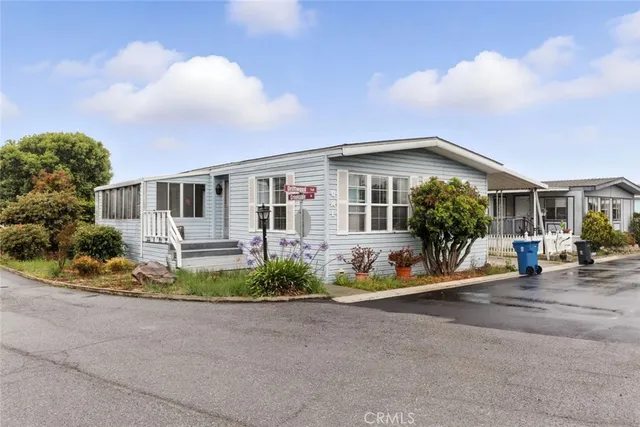 a front view of a house with a yard and outdoor seating