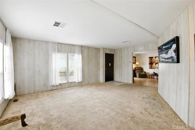 a view of a livingroom with furniture and a flat screen tv
