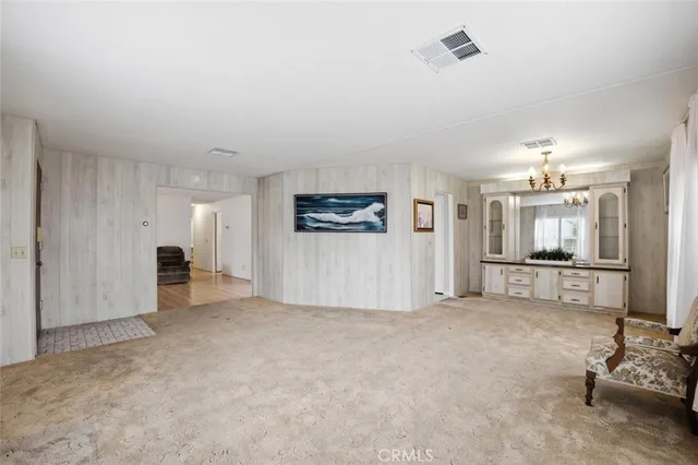 a view of a livingroom with an empty space and a window