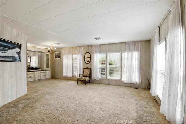 a large living room with furniture and a large mirror