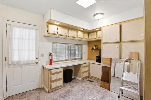 a view of a storage & utility room with a washer dryer