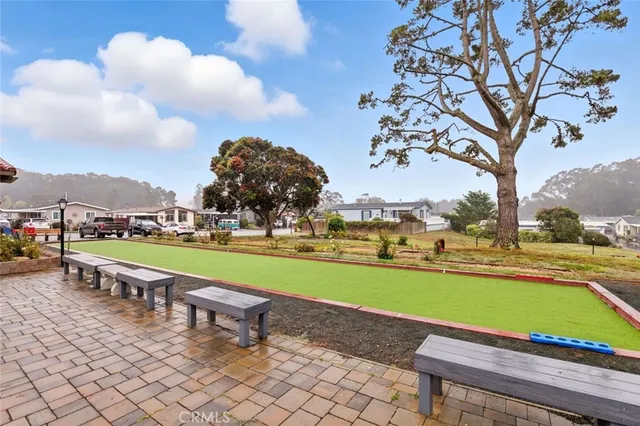a view of a house with a fountain in a yard