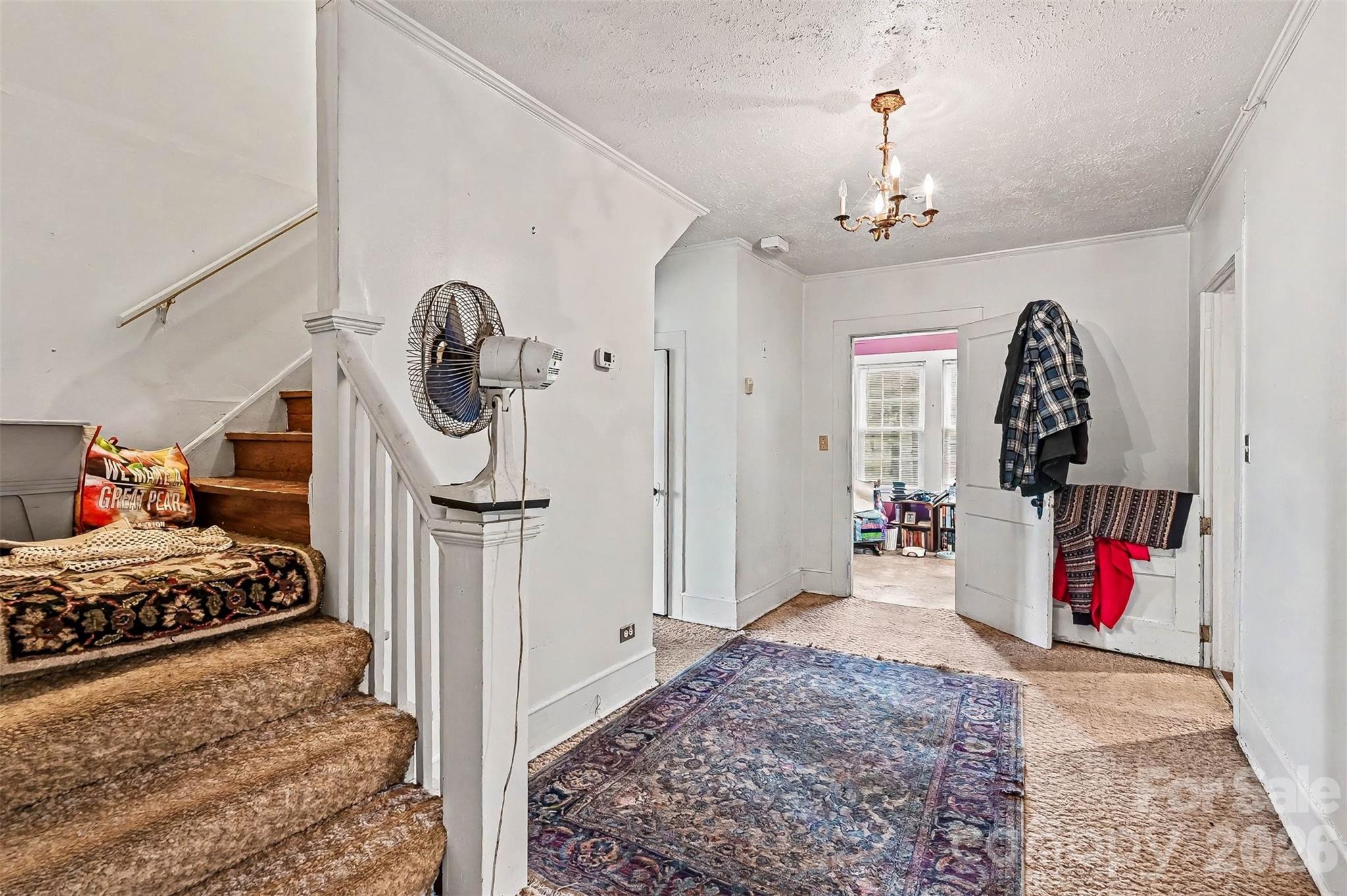 1116 Medlin Road Monroe, NC 28112 - Photo 24 of 40 a very nice looking bedroom with a bed dresser and a chandelier