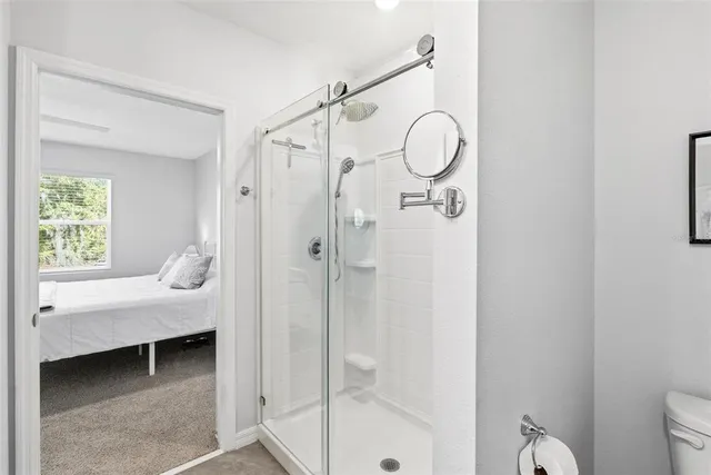 a en suite bathroom with a shower a mirror and a sink