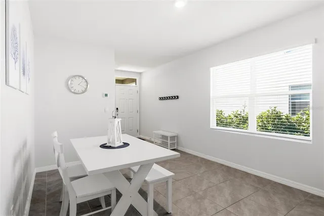 a view of a dining room that has a table and a chair with wooden floor
