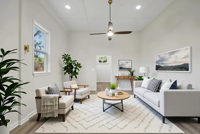 a living room with furniture and a large window