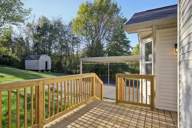 a view of a street with wooden fence
