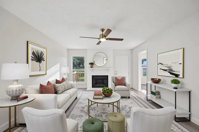 a living room with furniture a fireplace and a wall painting