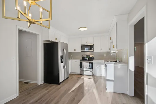 a kitchen with stainless steel appliances a refrigerator stove microwave and sink