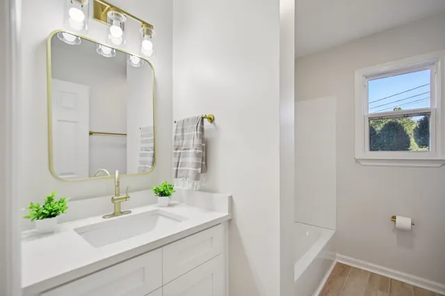 a bathroom with a sink and a mirror