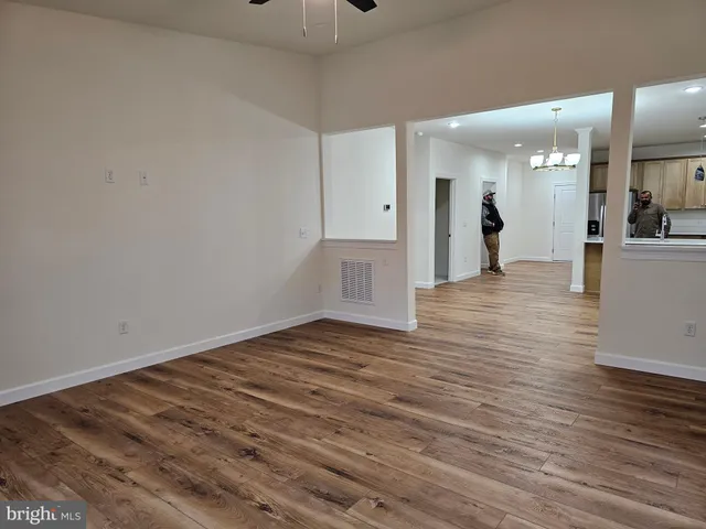 a view of a big room with wooden floor and a bathroom