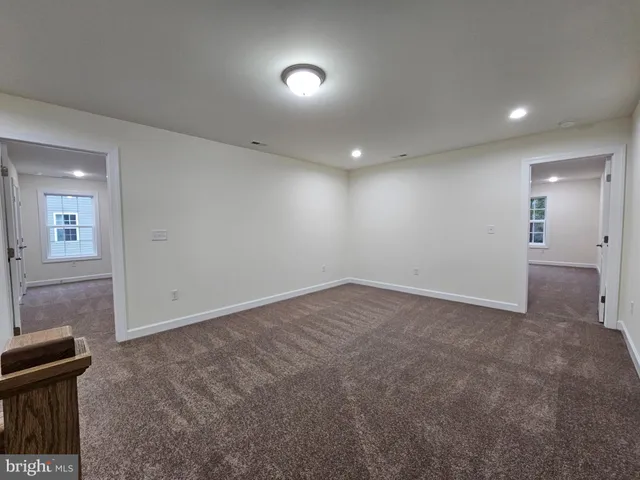 an empty room with windows and entrance