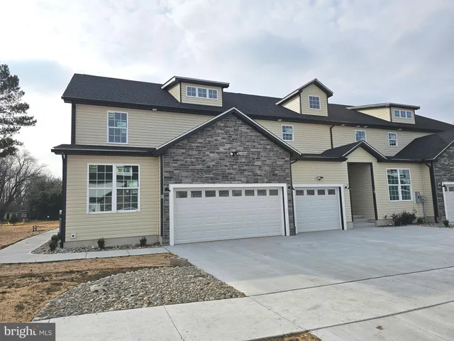 a front view of a house with garage