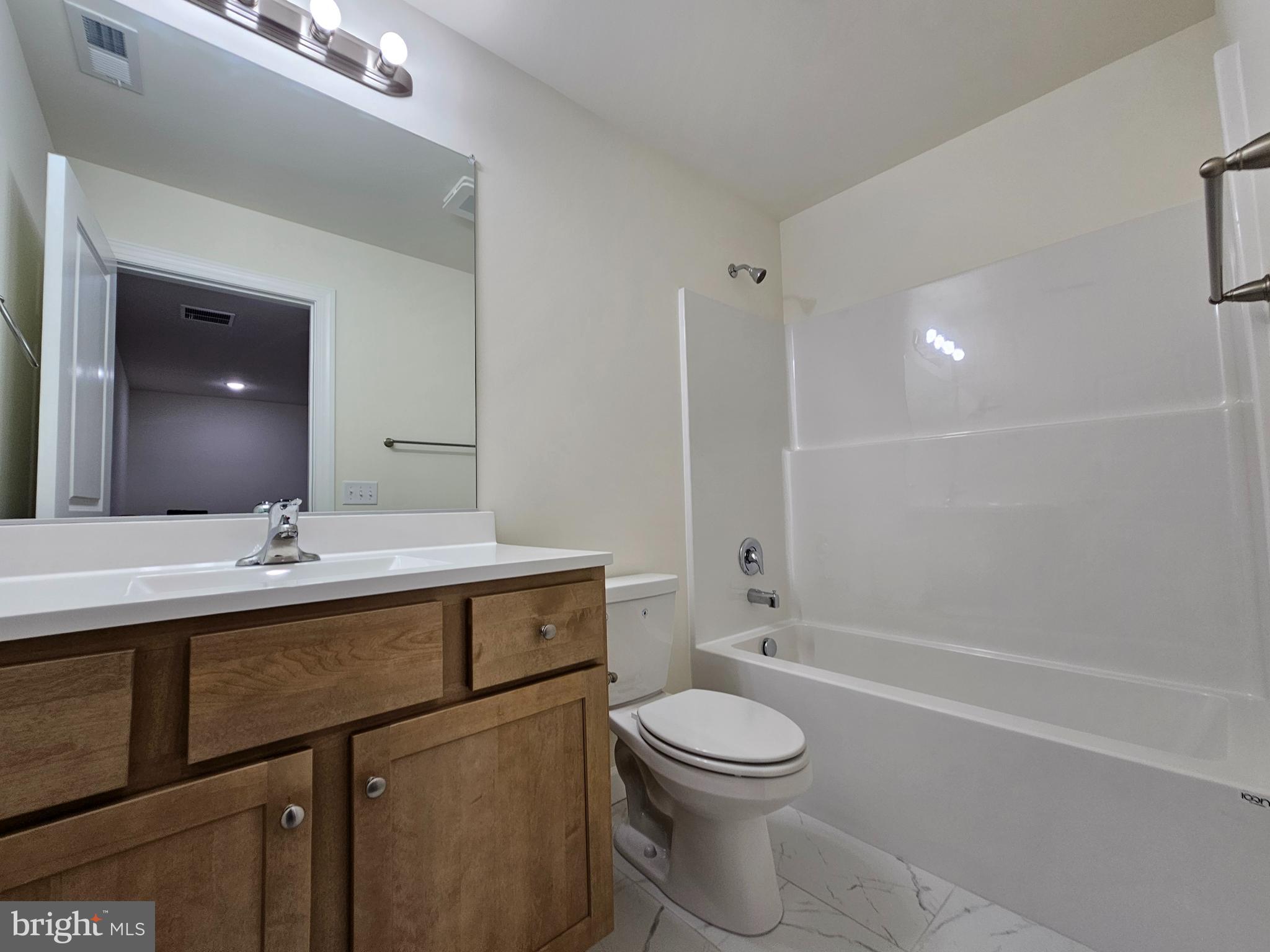 6 Valhalla Court Dover, DE 19904 - Photo 23 of 40 a bathroom with a sink a toilet and shower