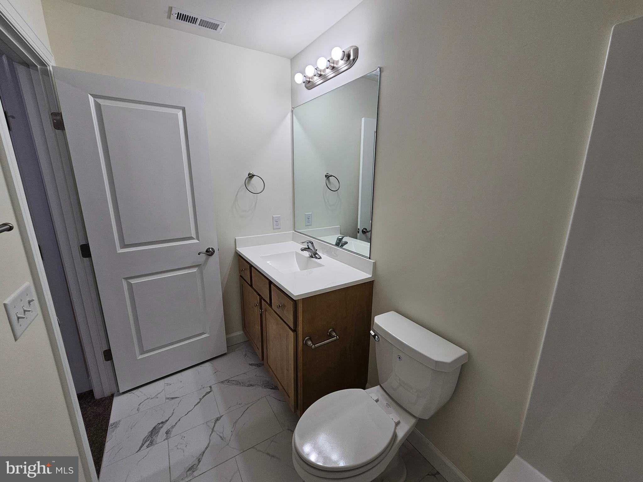 6 Valhalla Court Dover, DE 19904 - Photo 24 of 40 a bathroom with a sink a toilet a mirror and vanity
