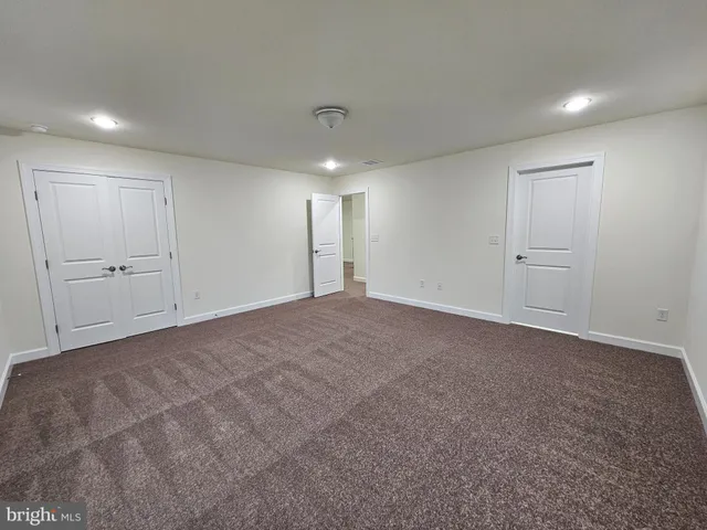 a white toilet sitting next to a bath tub