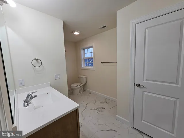 a spacious bathroom with a bathtub sink and mirror