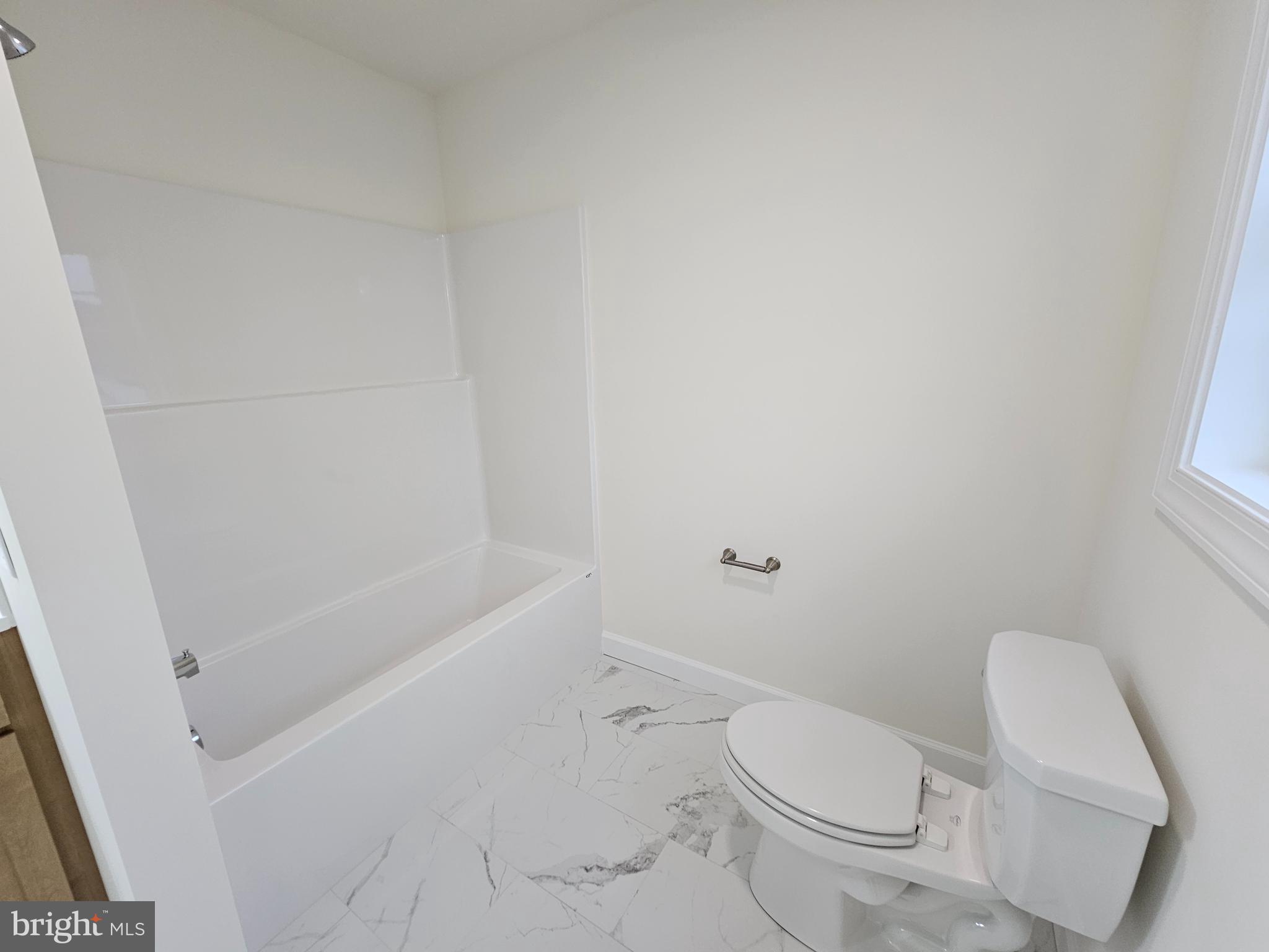 6 Valhalla Court Dover, DE 19904 - Photo 28 of 40 a white toilet sitting next to a bath tub