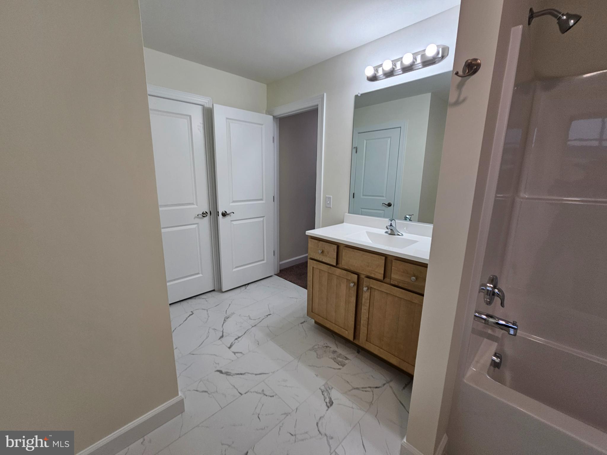 6 Valhalla Court Dover, DE 19904 - Photo 29 of 40 a spacious bathroom with a bathtub sink and mirror