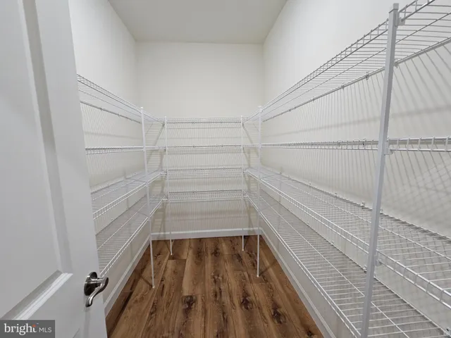 an empty room with closet and windows