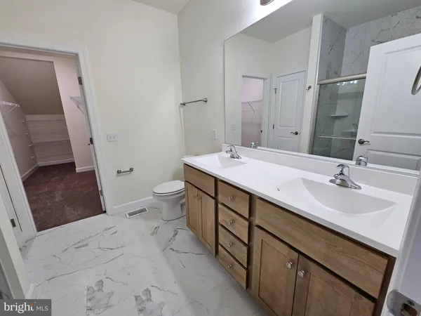 a bathroom with a sink vanity mirror and toilet