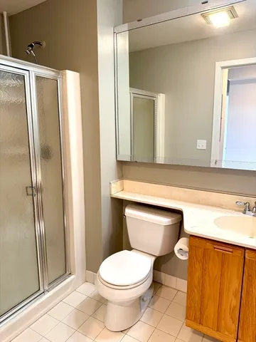 a bathroom with a toilet a sink and a mirror