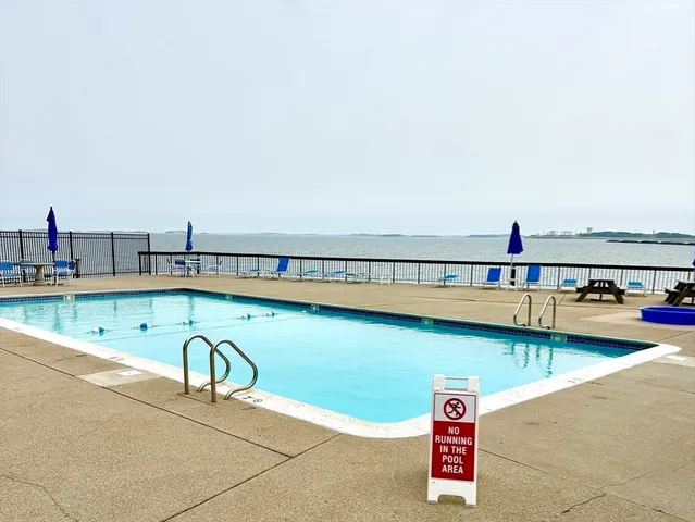 a view of a swimming pool and an outdoor seating