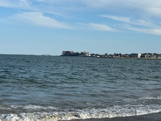 a view of ocean next to a tall building