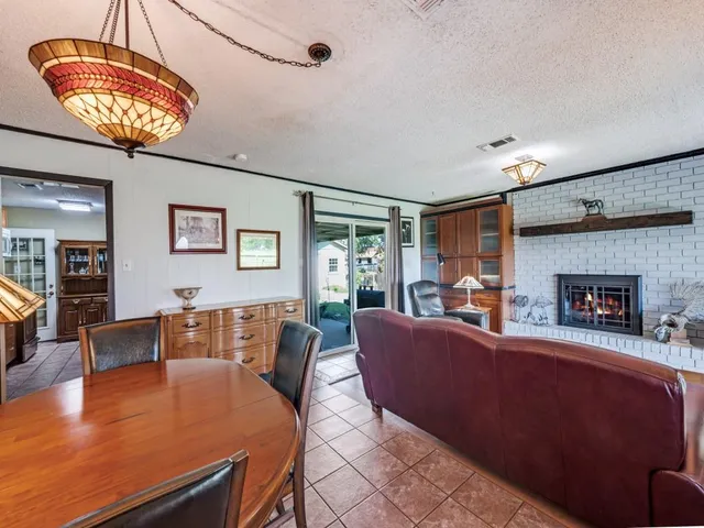 a bedroom with furniture and a large window