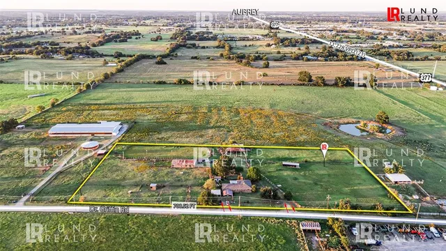 a view of a outdoor space with a table and chairs under an umbrella