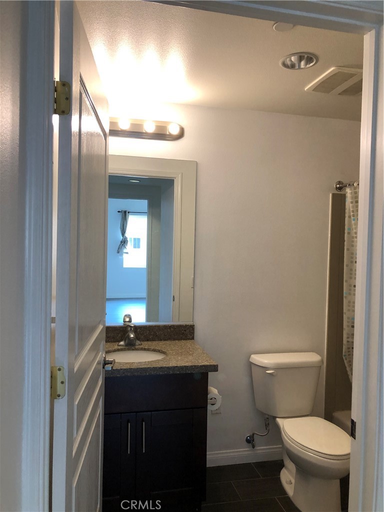 11 South 3rd Street, Unit 421 Alhambra, CA 91801 - Photo 12 of 17 a bathroom with a granite countertop sink toilet and a mirror