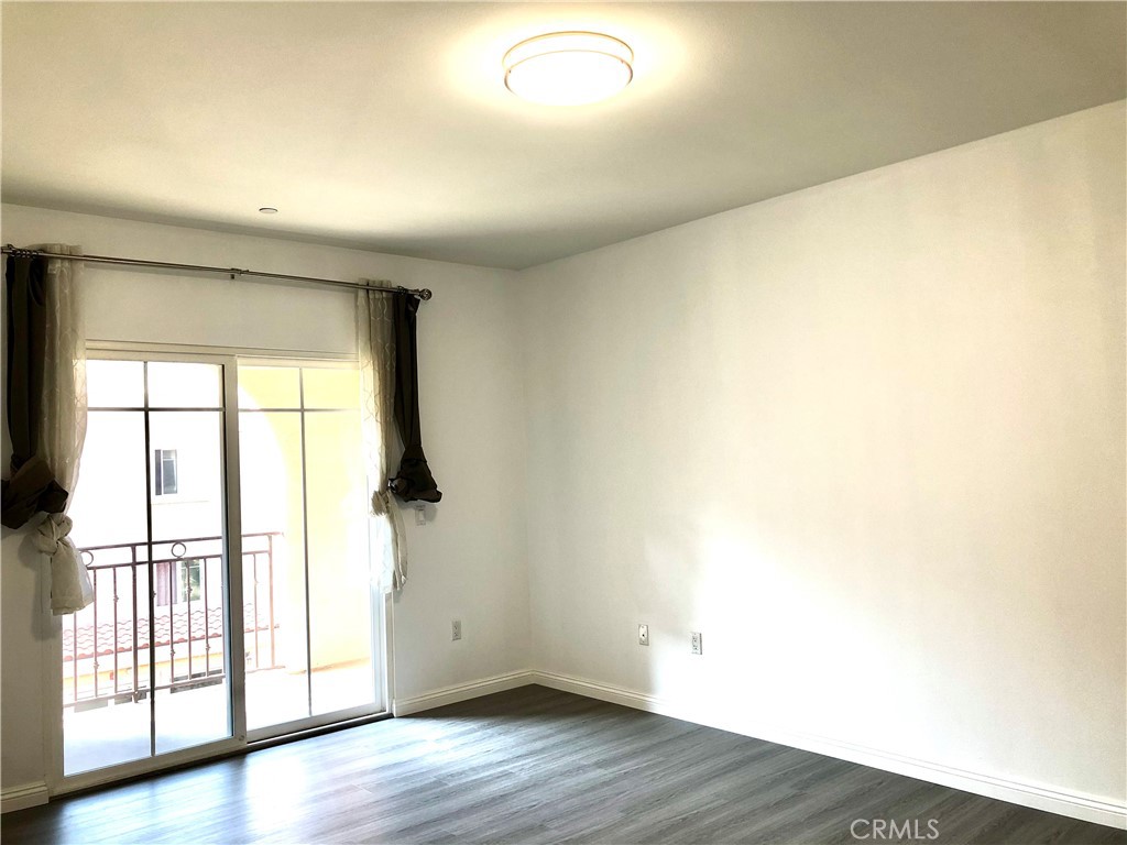 11 South 3rd Street, Unit 421 Alhambra, CA 91801 - Photo 14 of 17 an empty room with wooden floor and windows