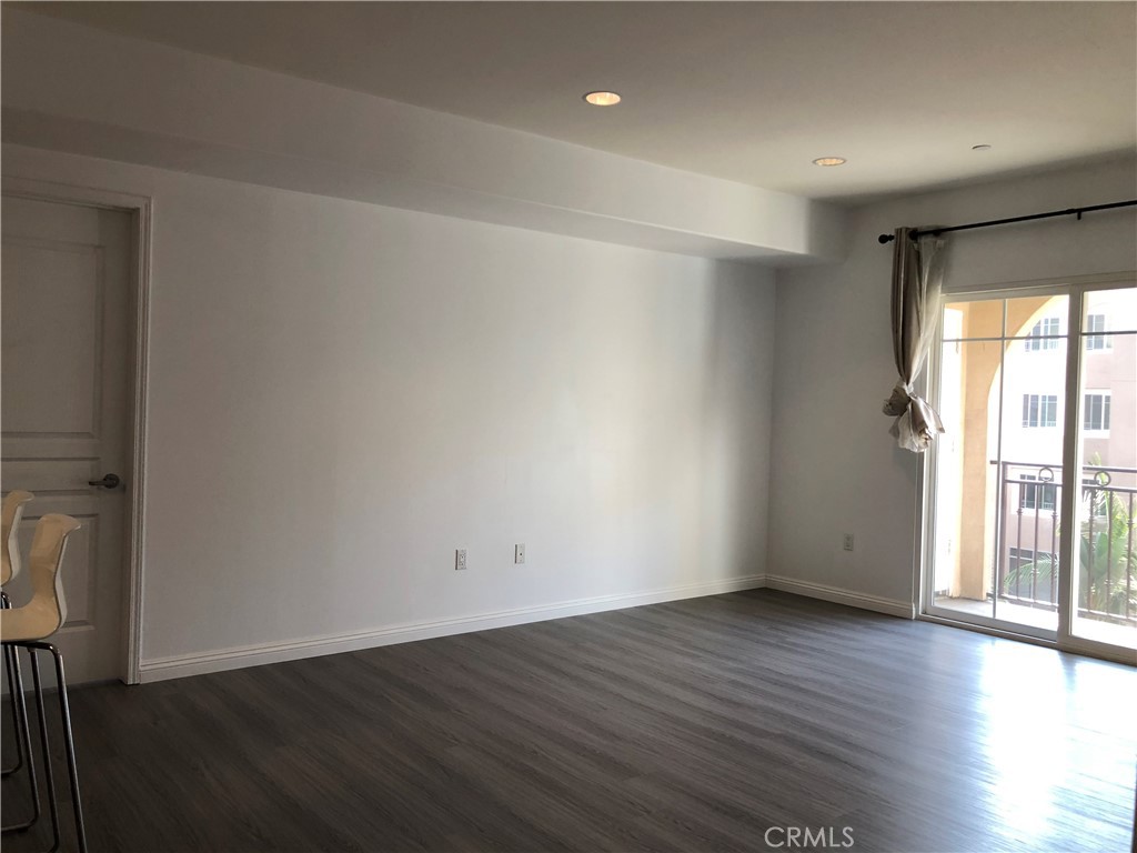 11 South 3rd Street, Unit 421 Alhambra, CA 91801 - Photo 17 of 17 an empty room with wooden floor and windows