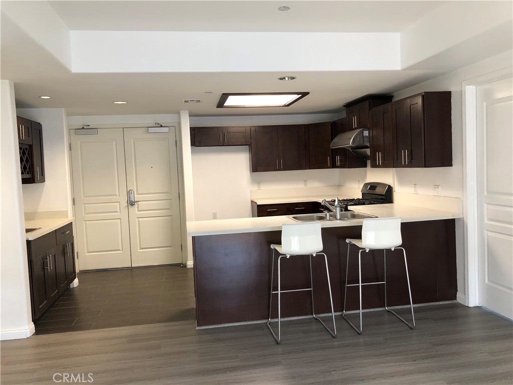 11 South 3rd Street, Unit 421 Alhambra, CA 91801 - Photo 8 of 17 a kitchen with granite countertop a stove a sink and a refrigerator
