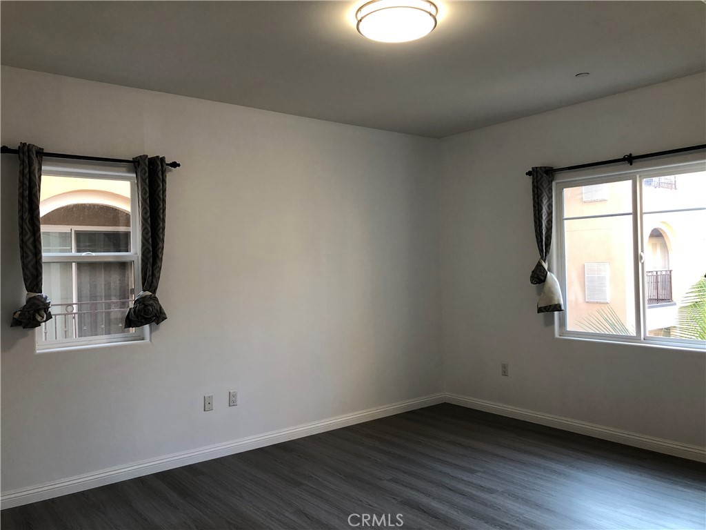 11 South 3rd Street, Unit 421 Alhambra, CA 91801 - Photo 10 of 17 an empty room with wooden floor and windows