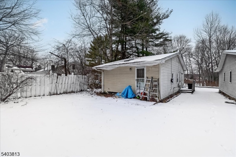 46 Wildwood Road Oak Ridge, NJ 07438 - Photo 2 of 6 a view of a house with a yard covered in snow