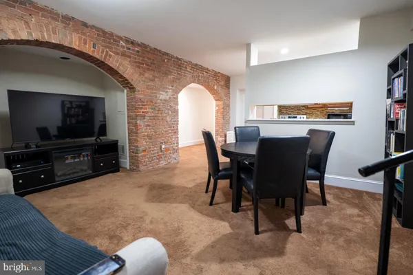 a view of a livingroom with furniture and a flat screen tv
