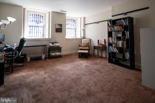 a livingroom with workspace and a window