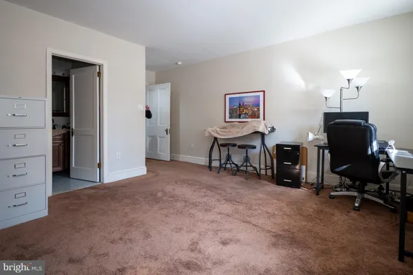 a view of a livingroom with workspace and a couch