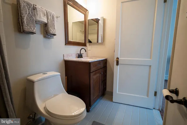 a white toilet sitting next to a bathroom sink