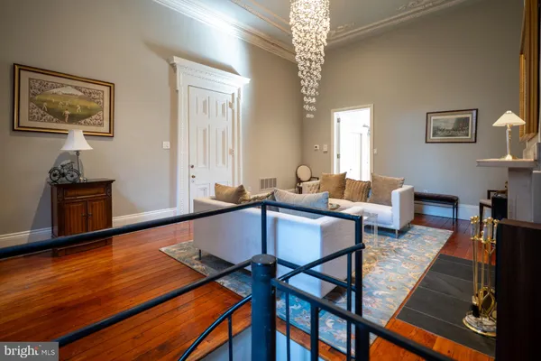 a living room with furniture and a chandelier