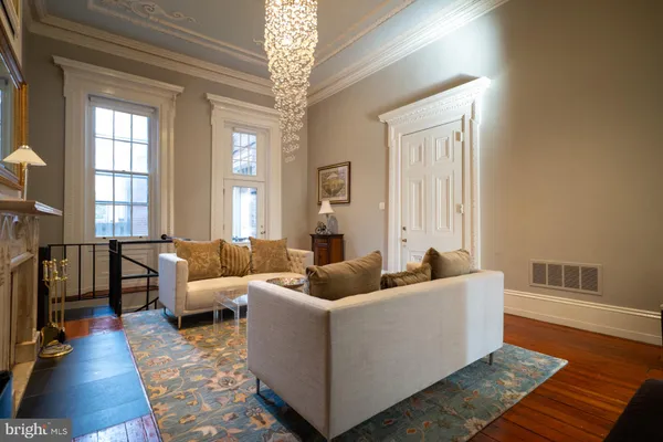a living room with furniture and a chandelier